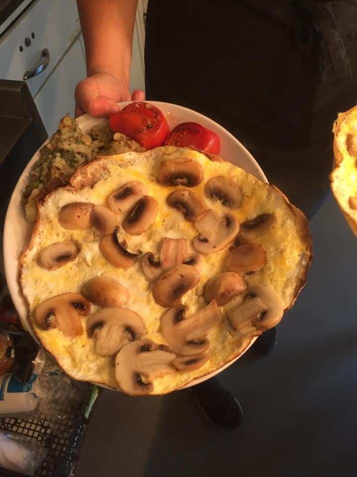 A mushroom omelette served with tomatoes