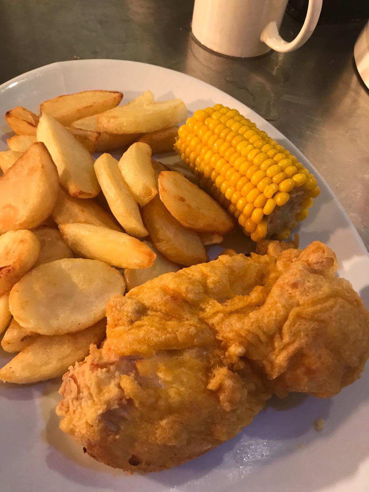 Battered chicken, chips and corn on the cob