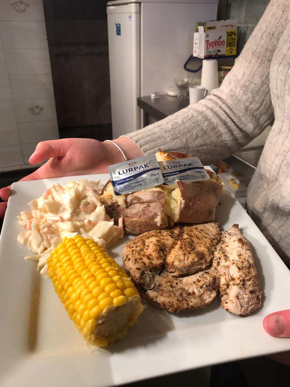 Cajun chicken with a jacket potato, salad and corn on the cob