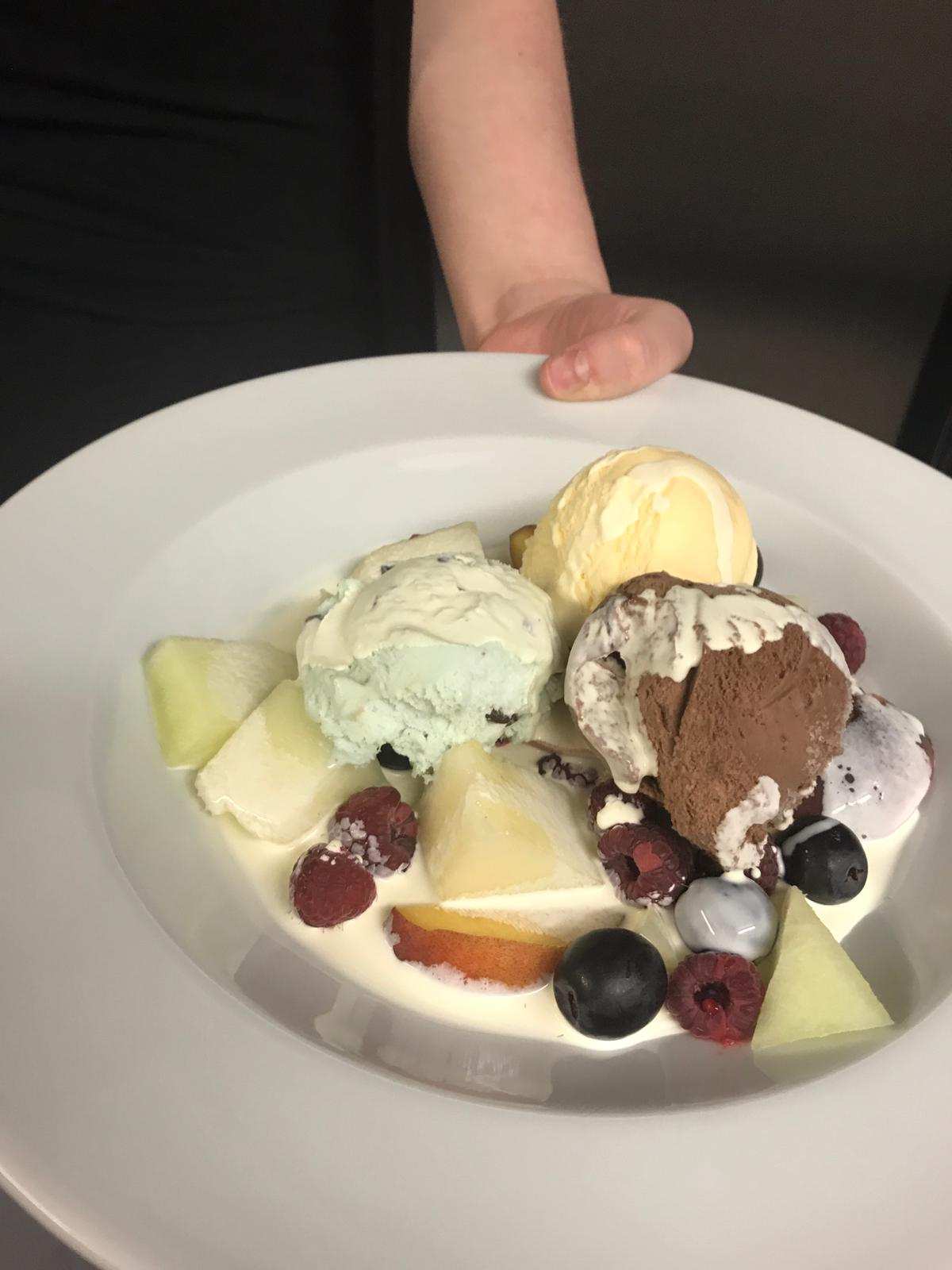 Fresh fruit salad with ice cream and cream