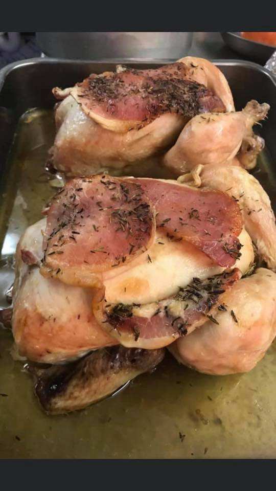 Roast chickens topped with bacon