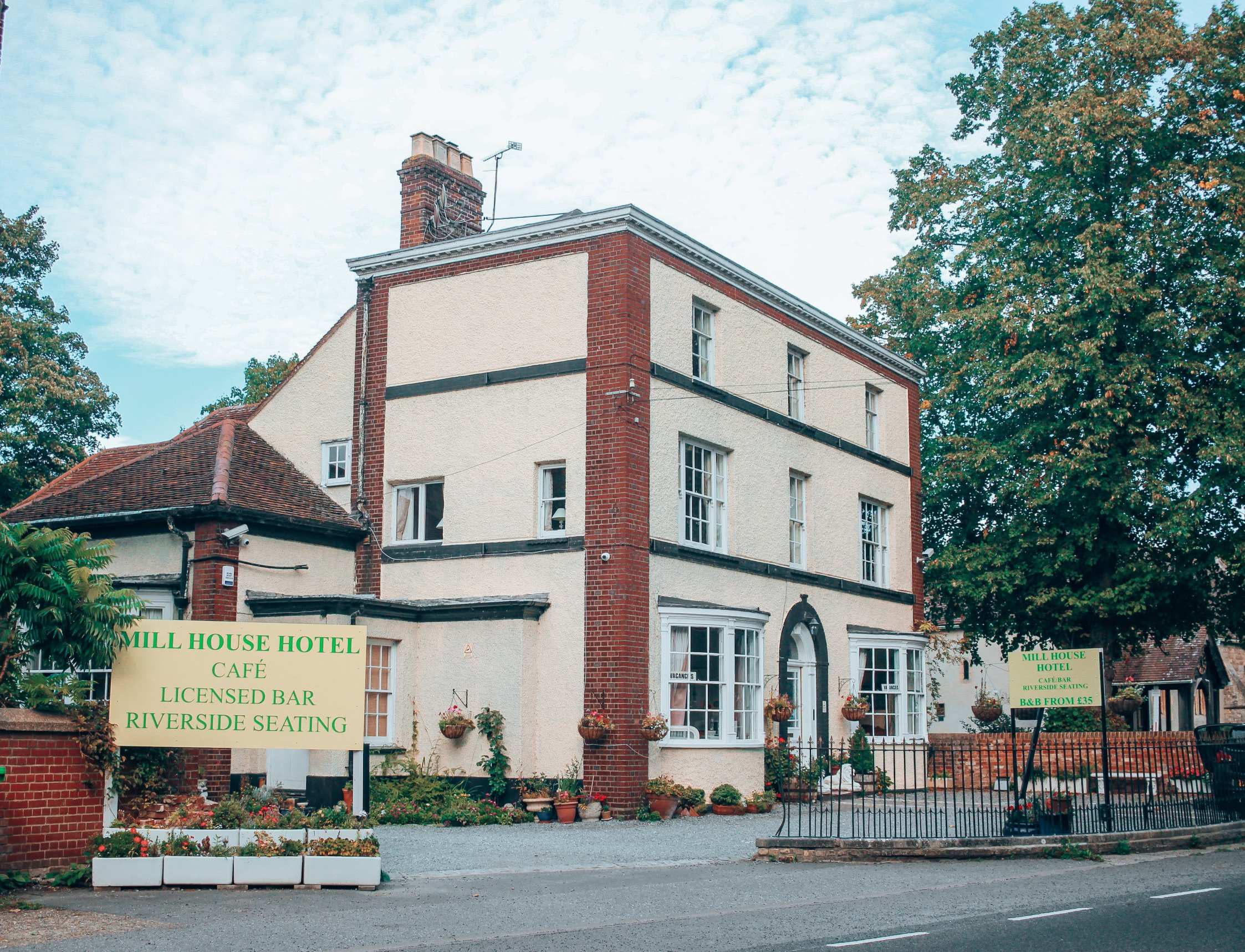 The hotel's white Georgian front and green sign