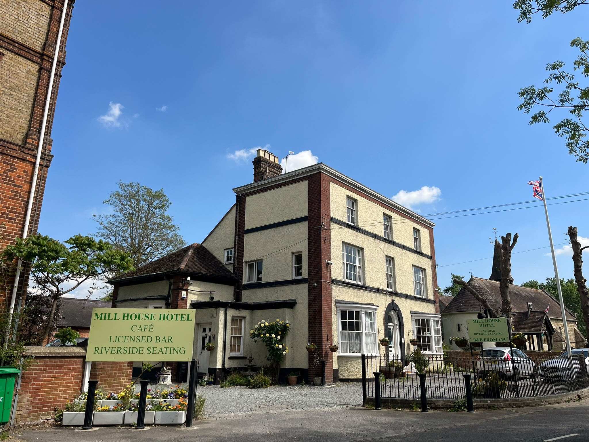 The hotel front with its sign: café, licensed bar, riverside seating