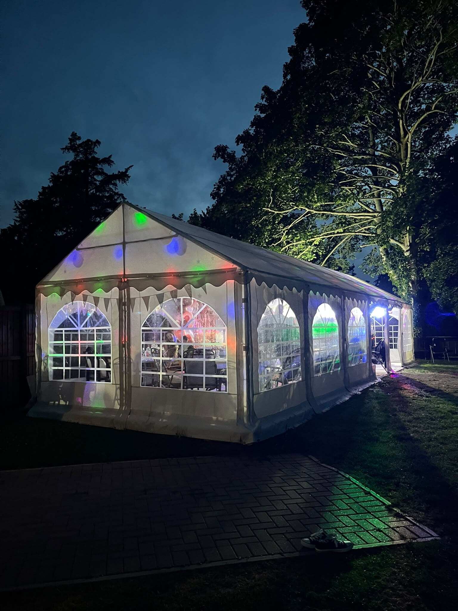The marquee lit up with party lights at night