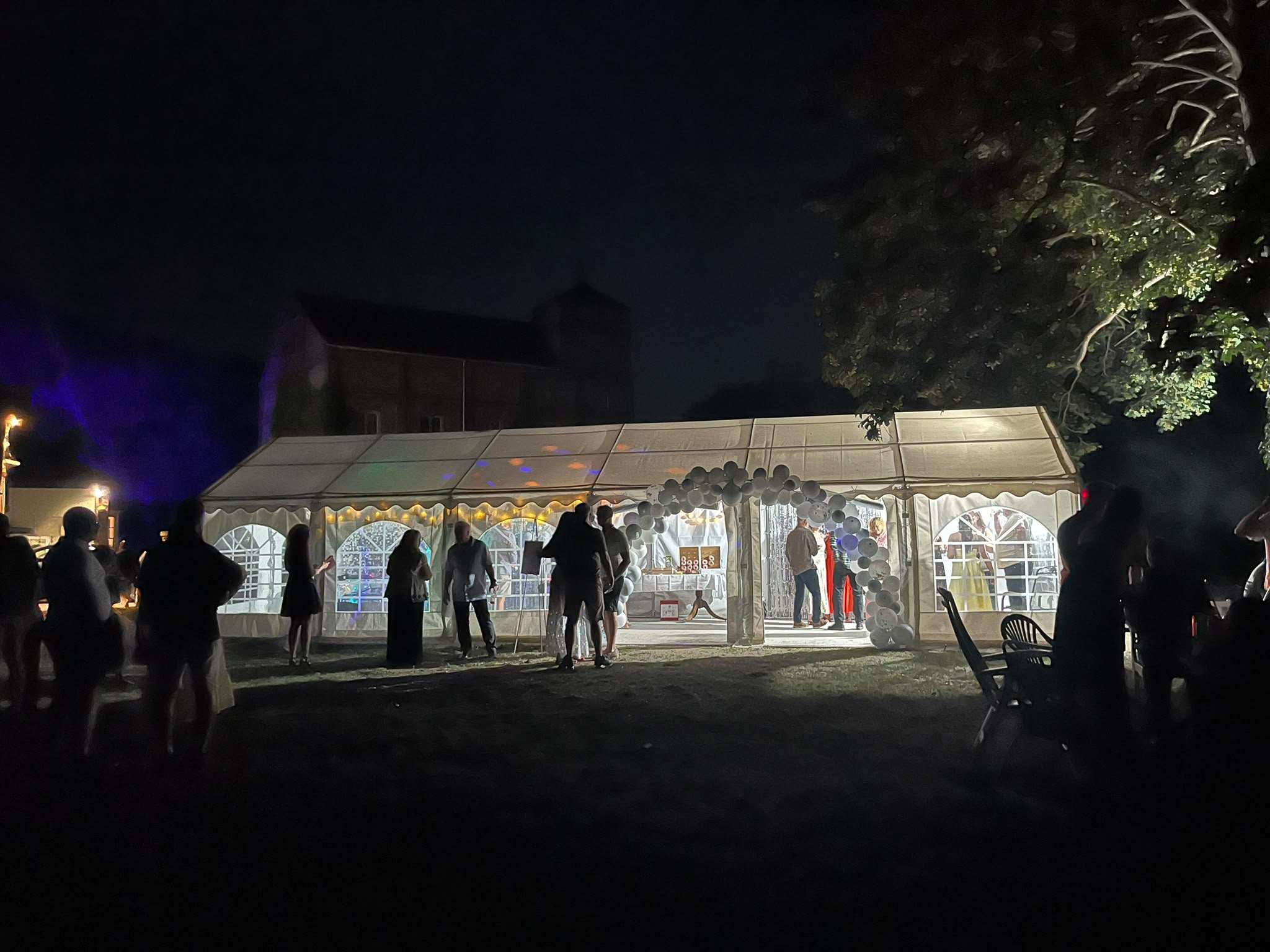 The marquee lit up at night during a party
